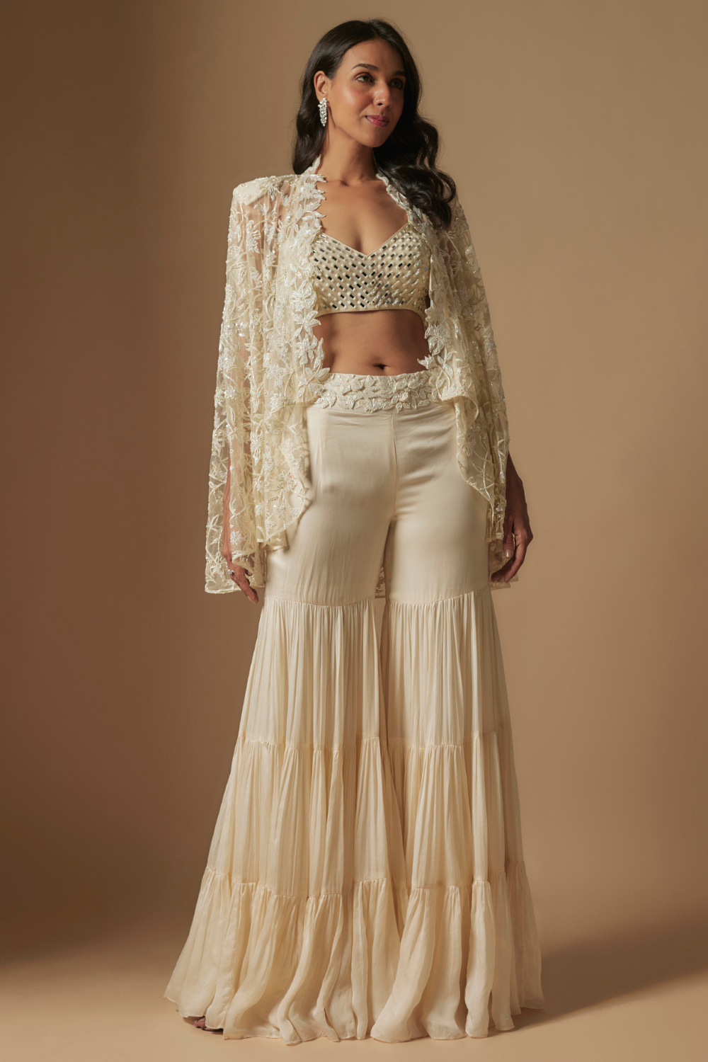 Orlique mirror work blouse paired with embroidered cape and sharara