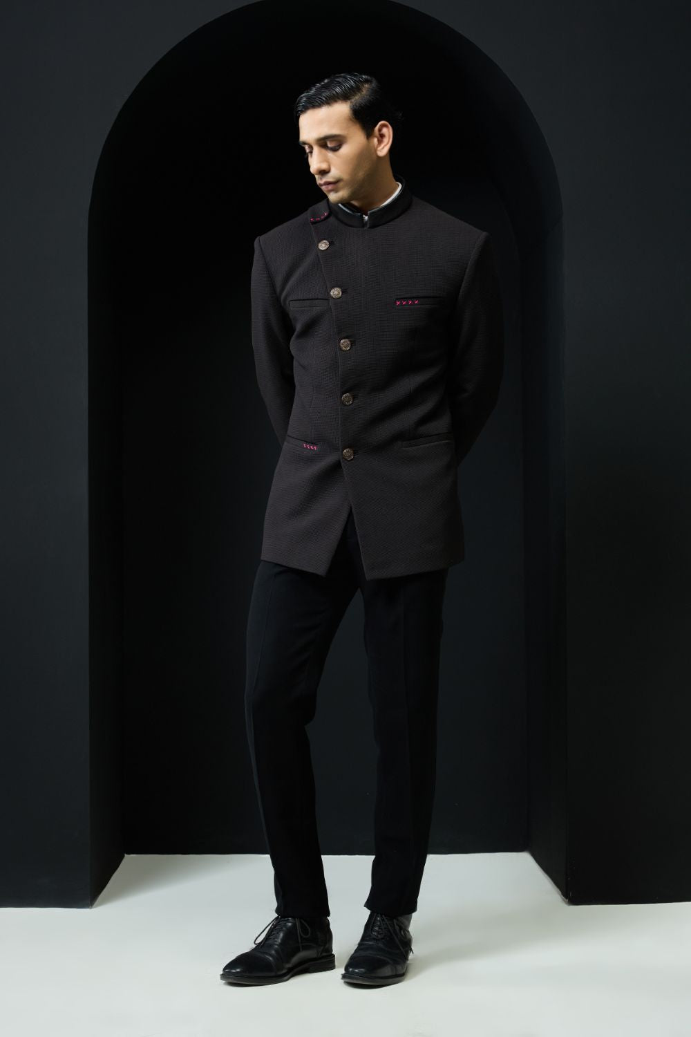 Black bandhgala with slant cut detailing with golden button and with satin taping