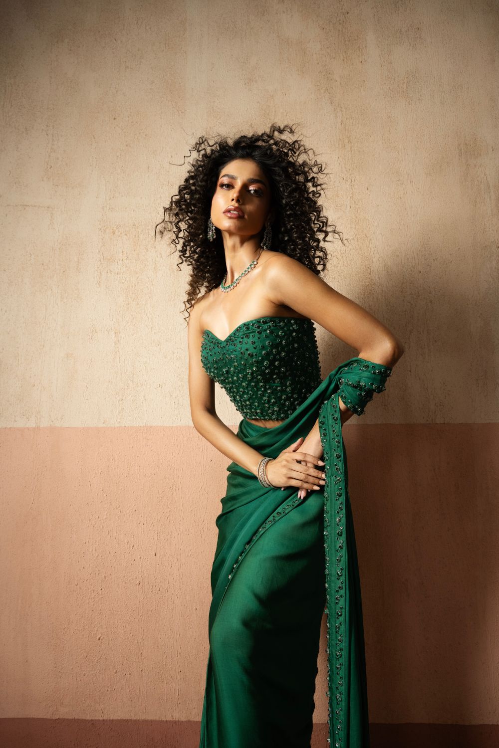 Predraped, emerald green hand embroidered satin saree with corset blouse