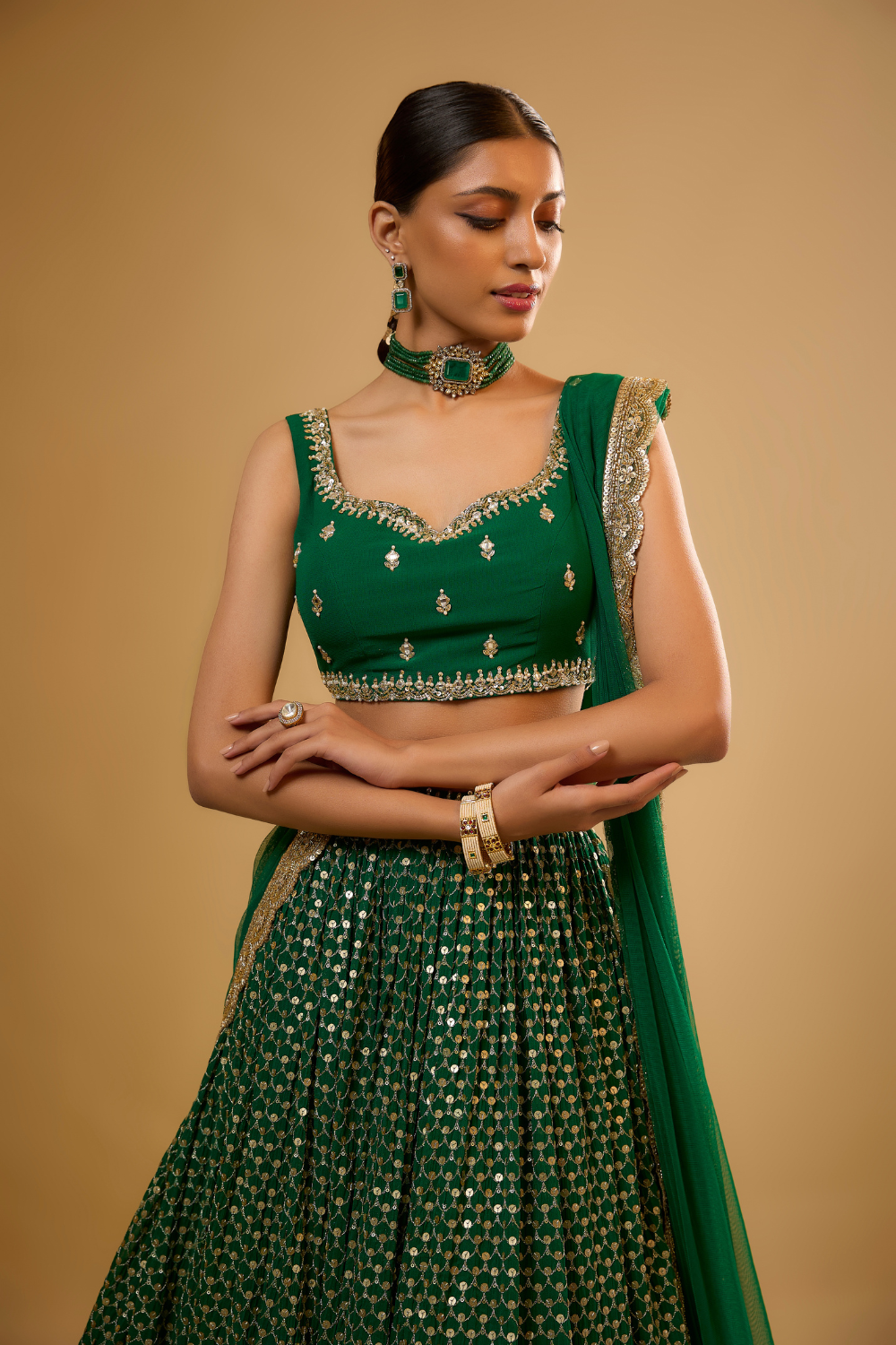 Emerald green georgette lehenga set embroidered with mirrors and gold sequins