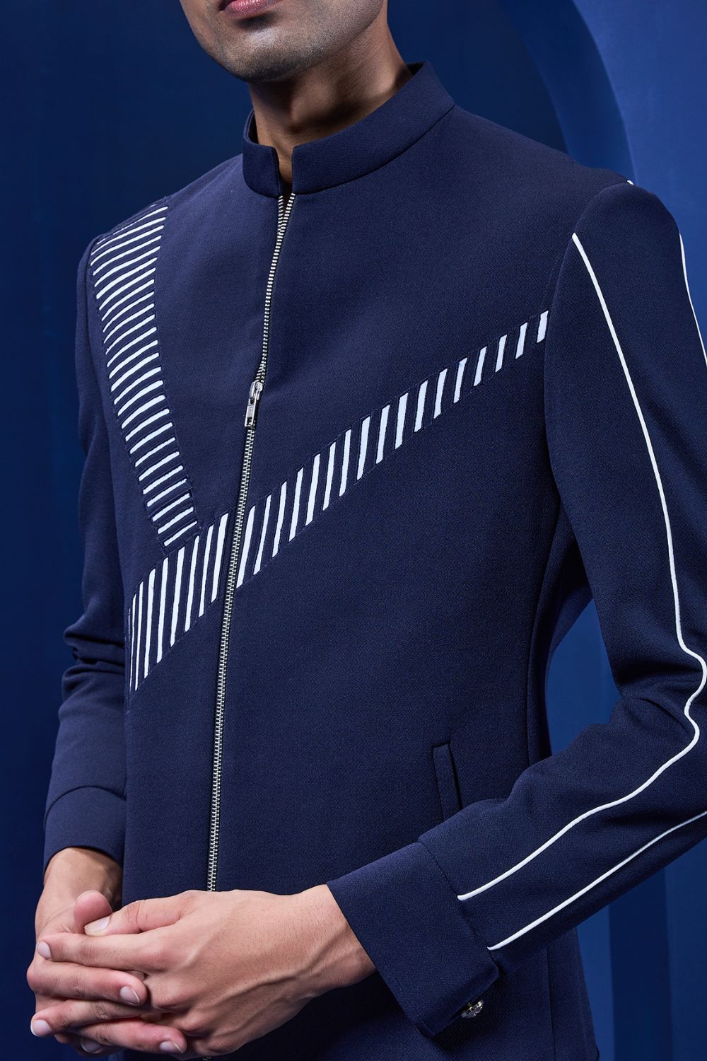 Navy blue jacket detailing with appliqué work and zipper