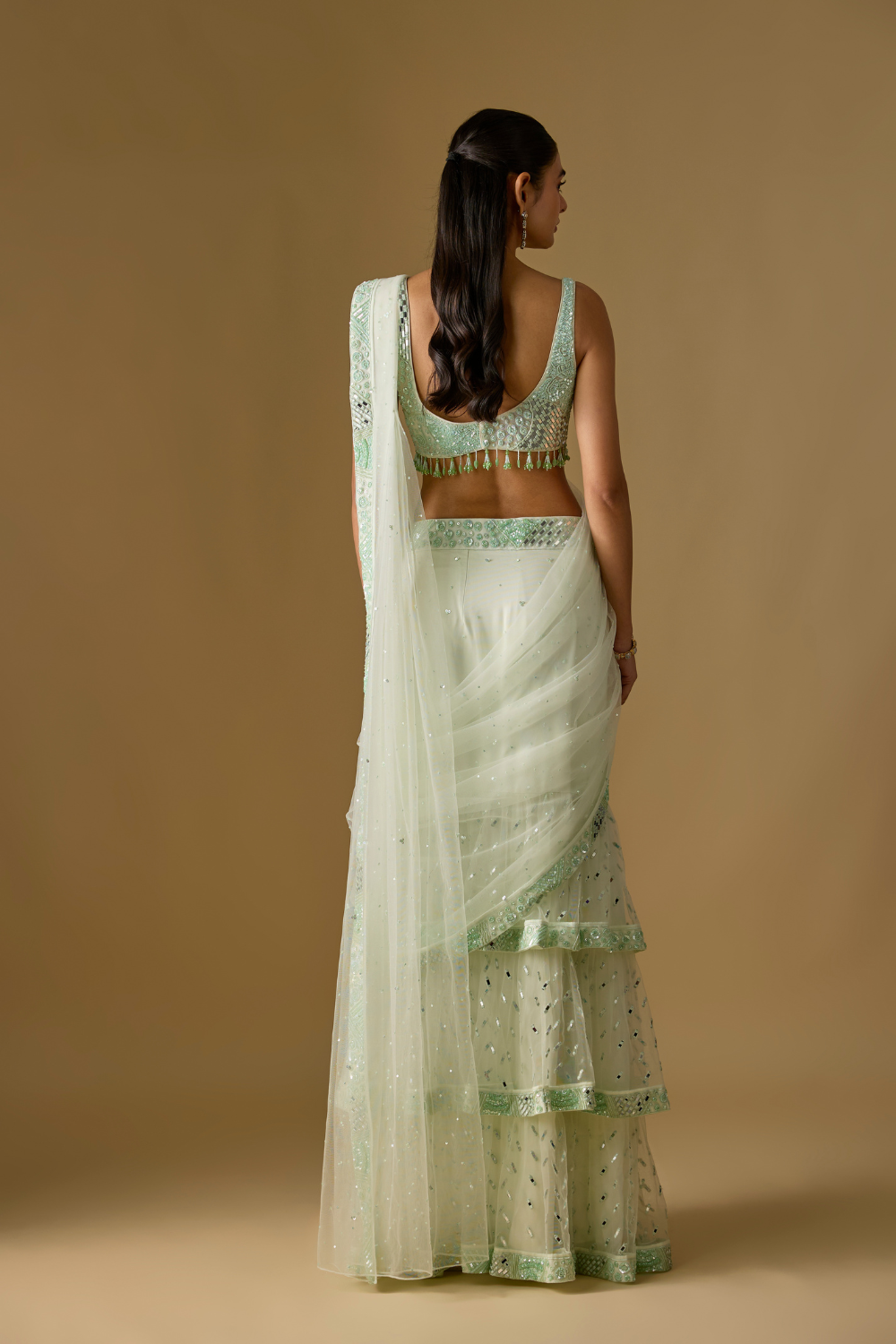 Aquaria- Mint designer pre draped saree in satin organza base with hand embroidery. It is paired with a tulle blouse.