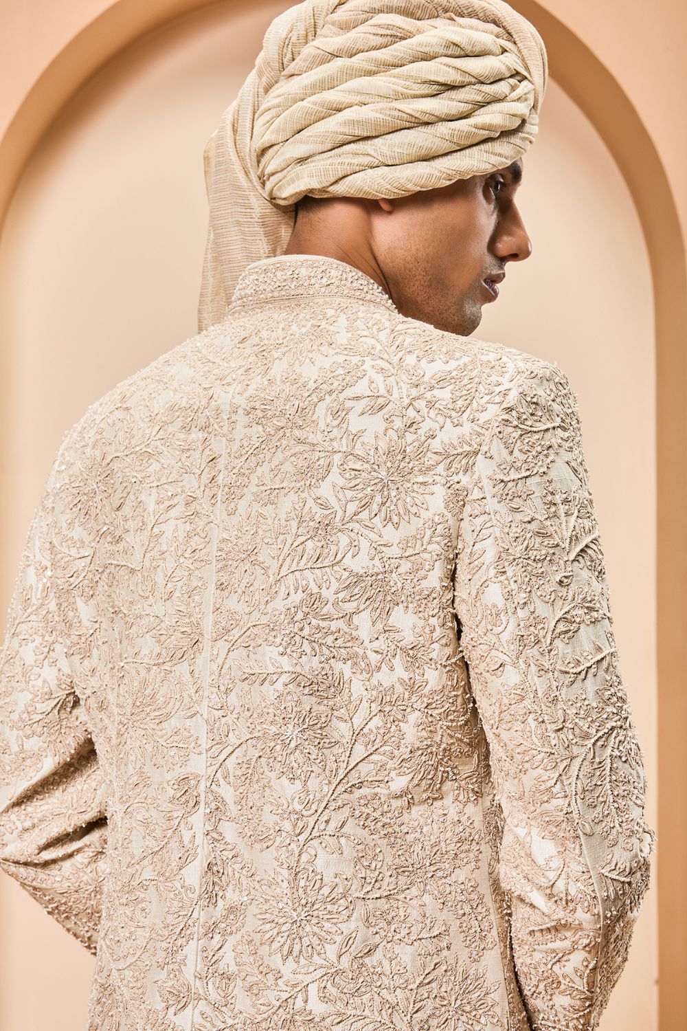 Ivory sherwani detailing with gold zari ,pearl,sequins and spring work