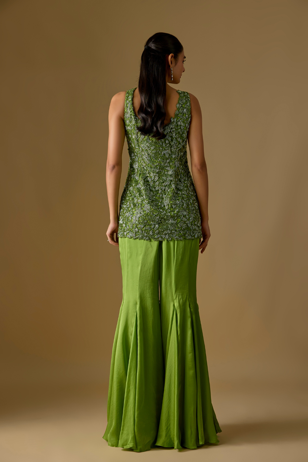 Driftlyn- Olive Green hand-embroidered short kurti paired with sharara and matching dupatta in satin organza and tulle fabric.
