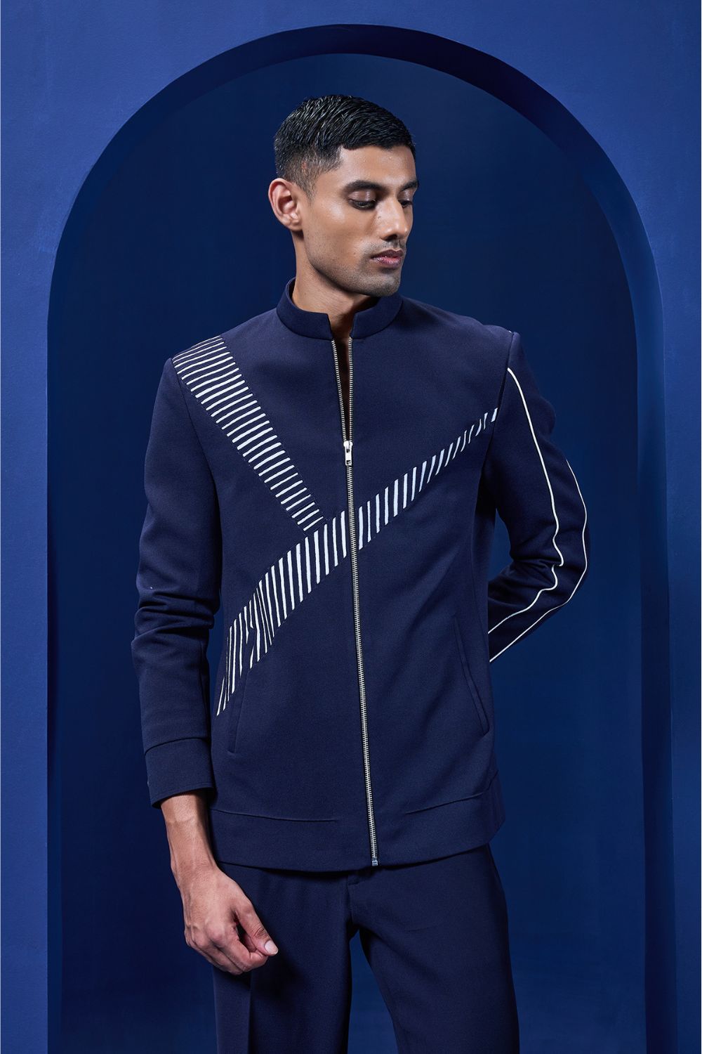 Navy blue jacket detailing with appliqué work and zipper