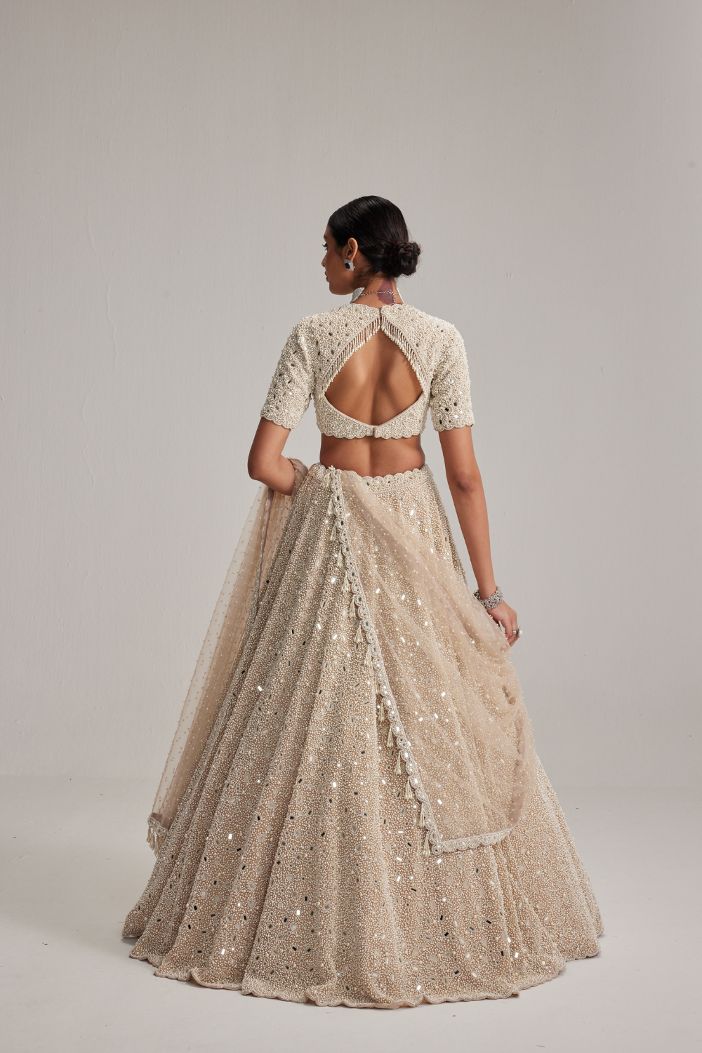 Light Beige Dense mirror and pearl lehenga set with High neck Blouse and Dupatta