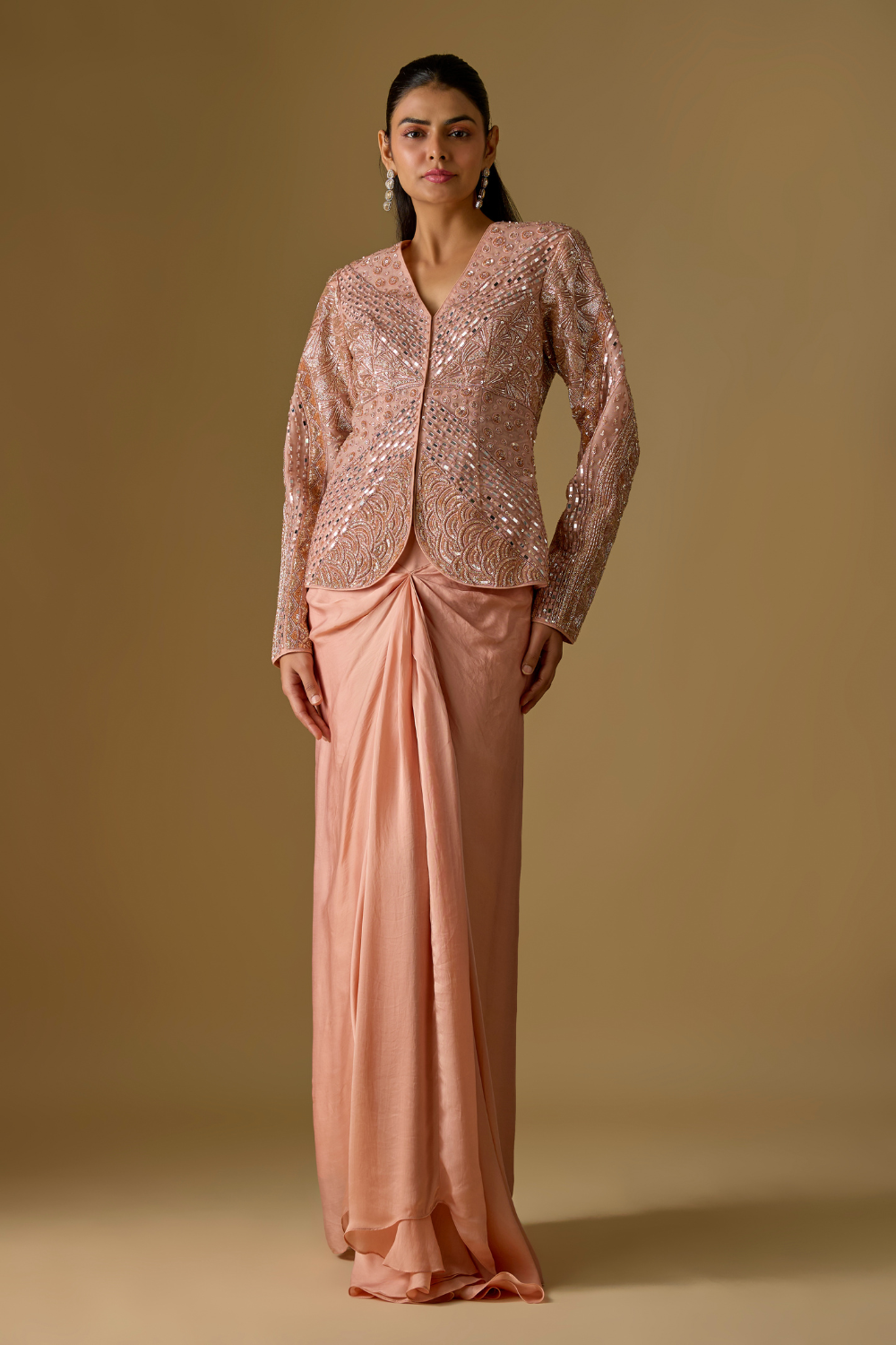 Coraqua- Rose gold short jacket in tulle base with hand embroidery. It is paired with satin organza draped skirt.