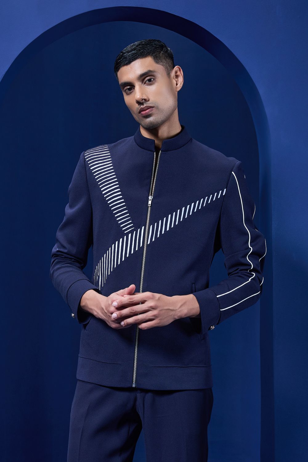 Navy blue jacket detailing with appliqué work and zipper