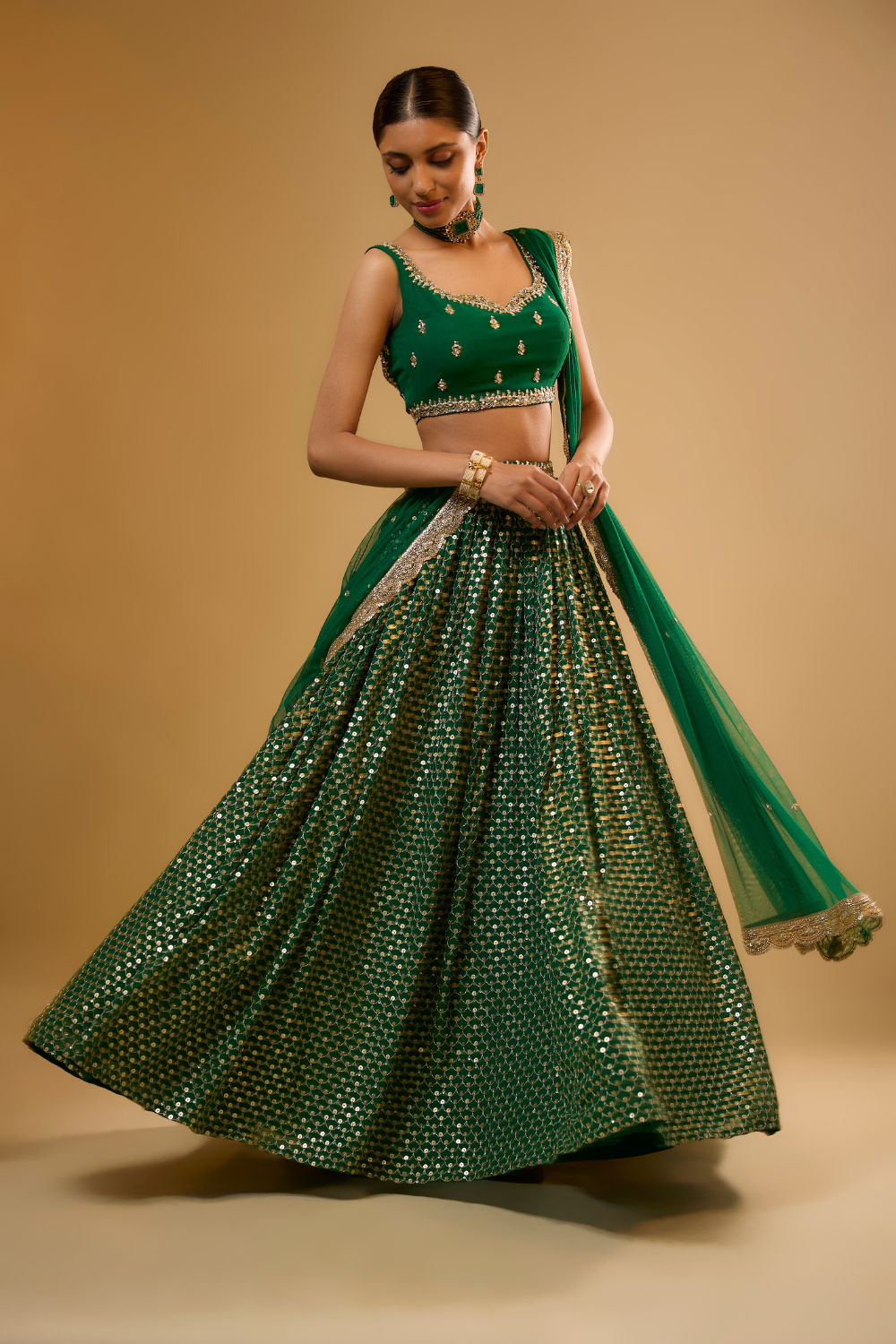 Emerald green georgette lehenga set embroidered with mirrors and gold sequins