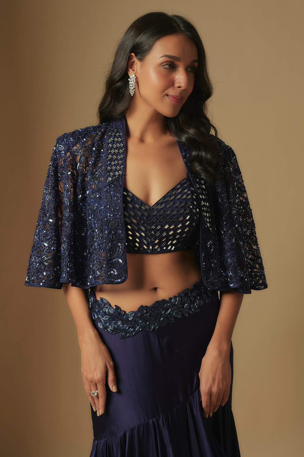 Marasu Mirror work blouse paired with hand embroidered cape and ruffled skirt