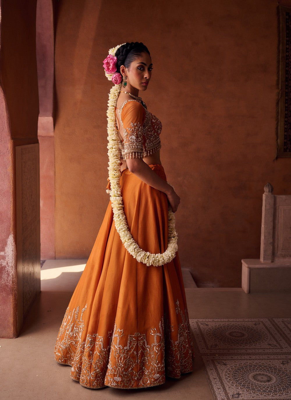 Rust orange embroidered blouse, shimmer tissue lehenga and dupatta