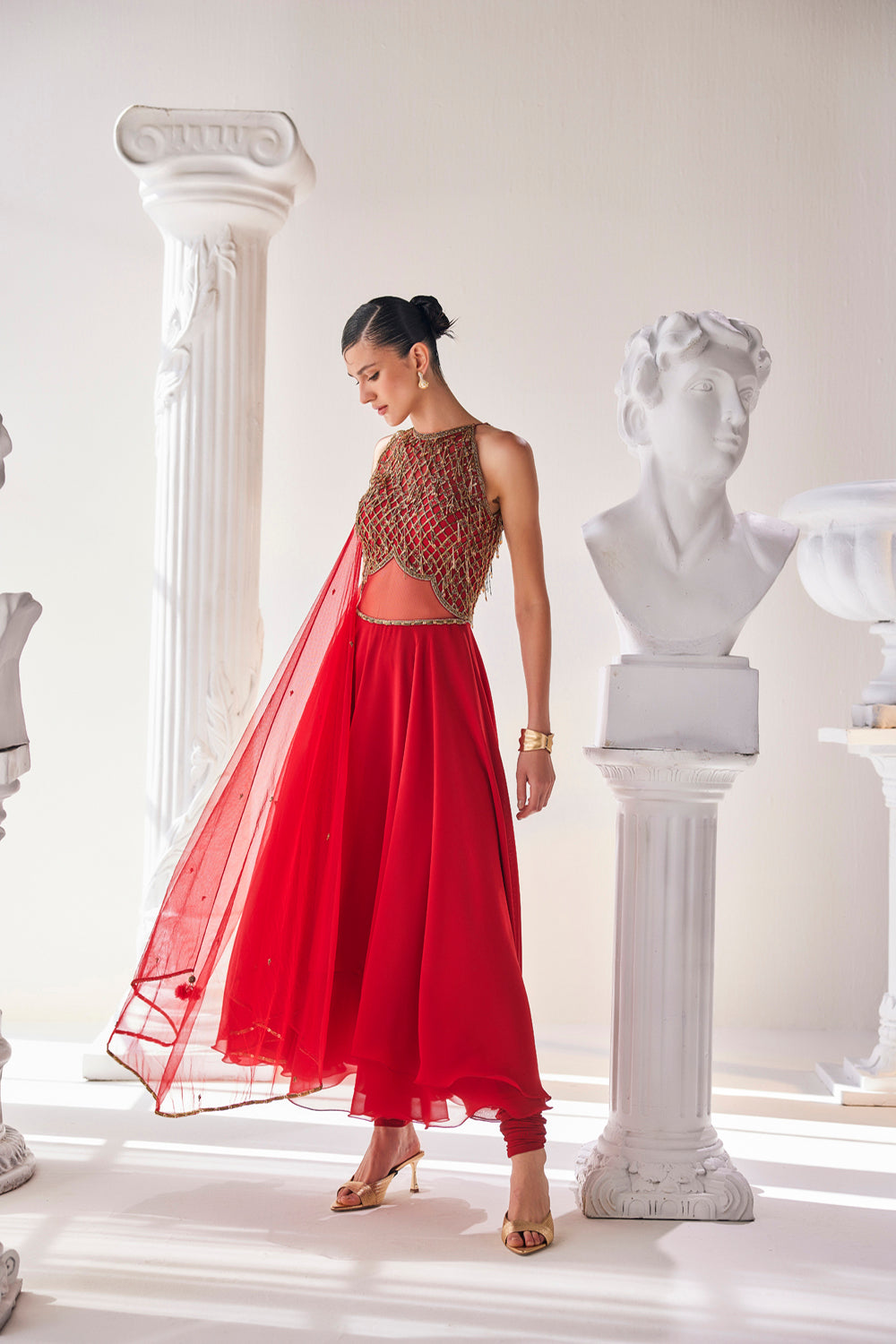 Red Georgette High Low Anarkali Designed With An Emroidered Bodice Paired
With A Churidar And A Net Dupatta.