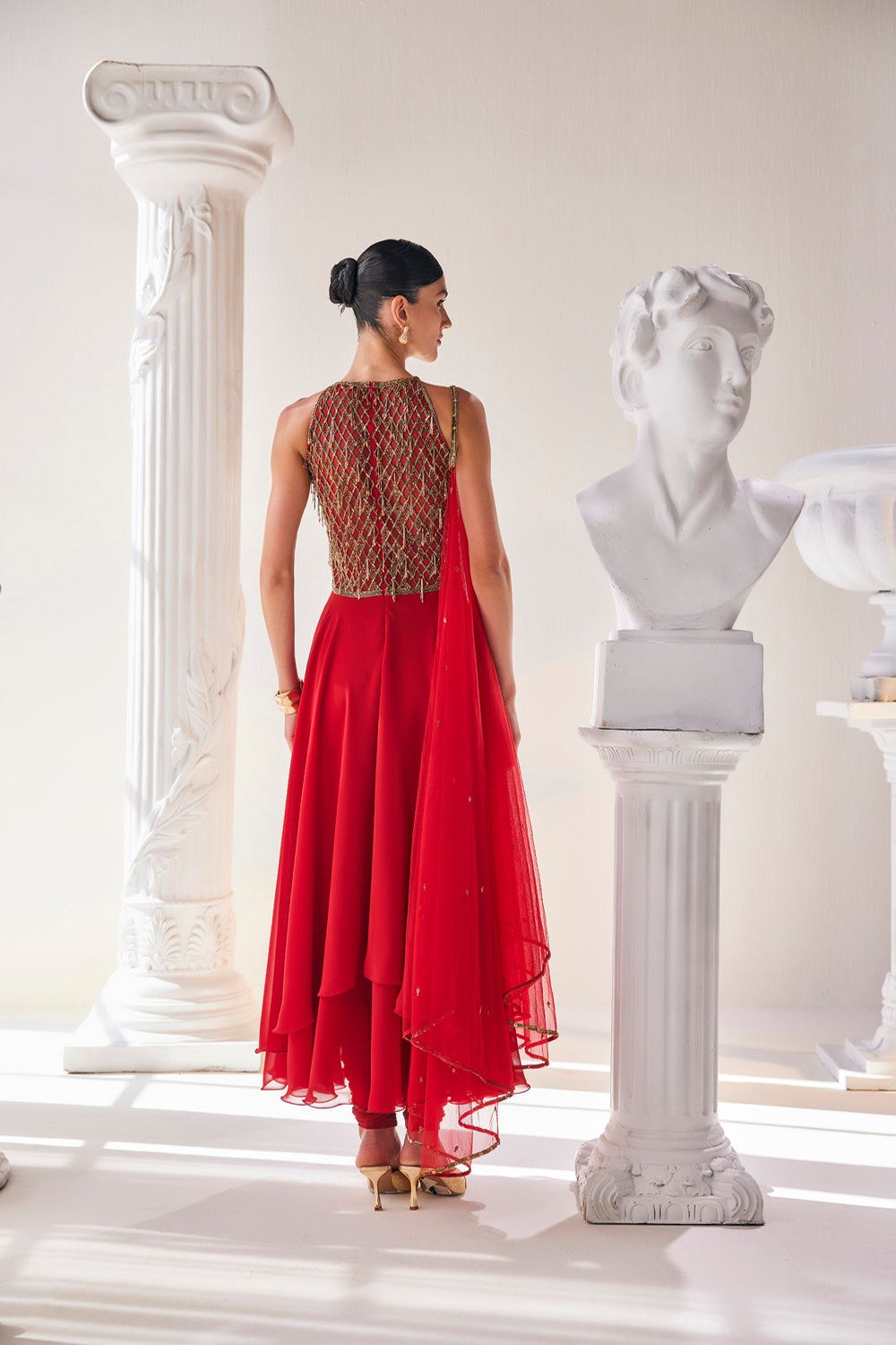 Red Georgette High Low Anarkali Designed With An Emroidered Bodice Paired
With A Churidar And A Net Dupatta.