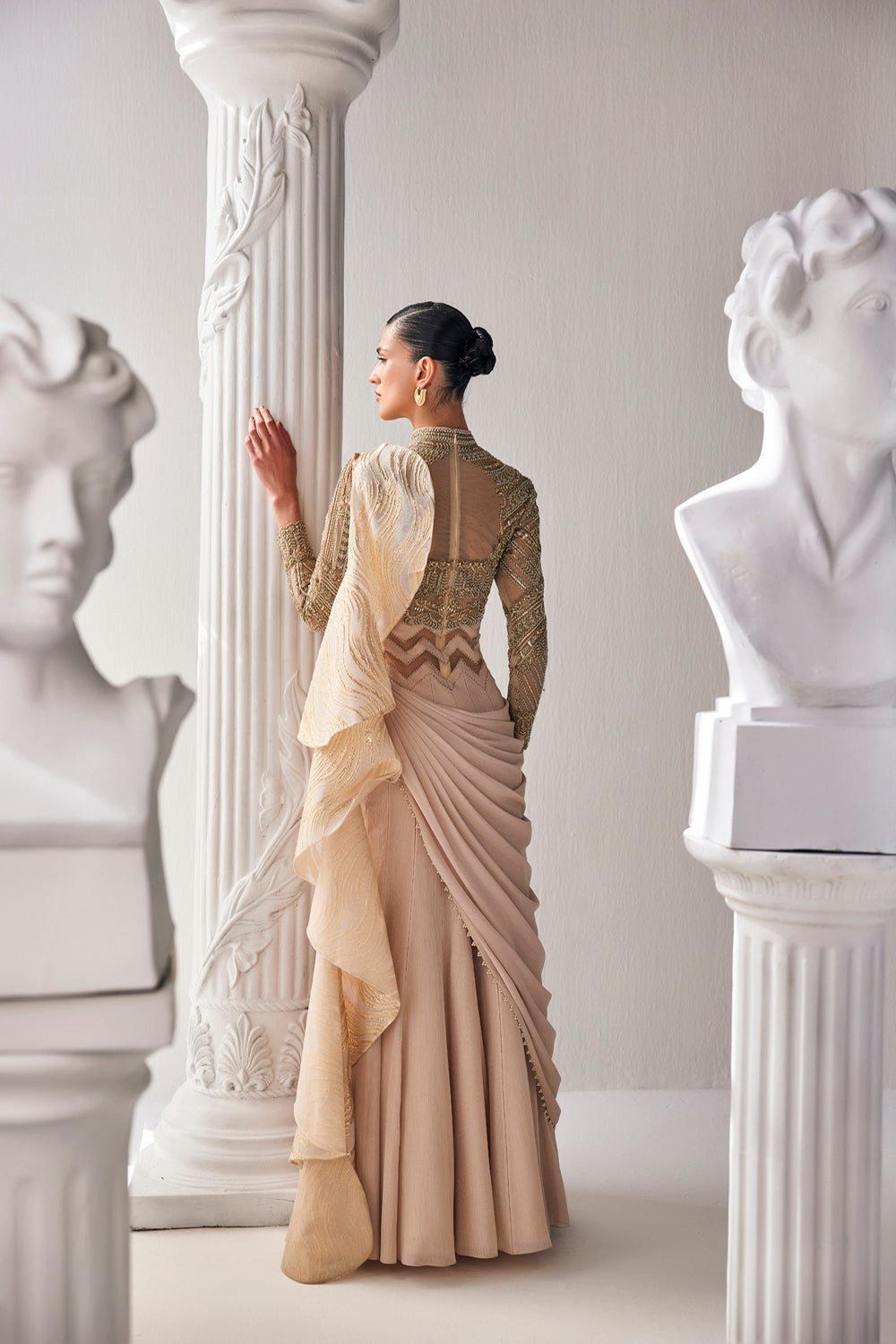 Golden Cream Draped Saree In Luxurious Shimmer Chiffon Offset With A Zardozi Blouse And An Elaborate High Neckline.