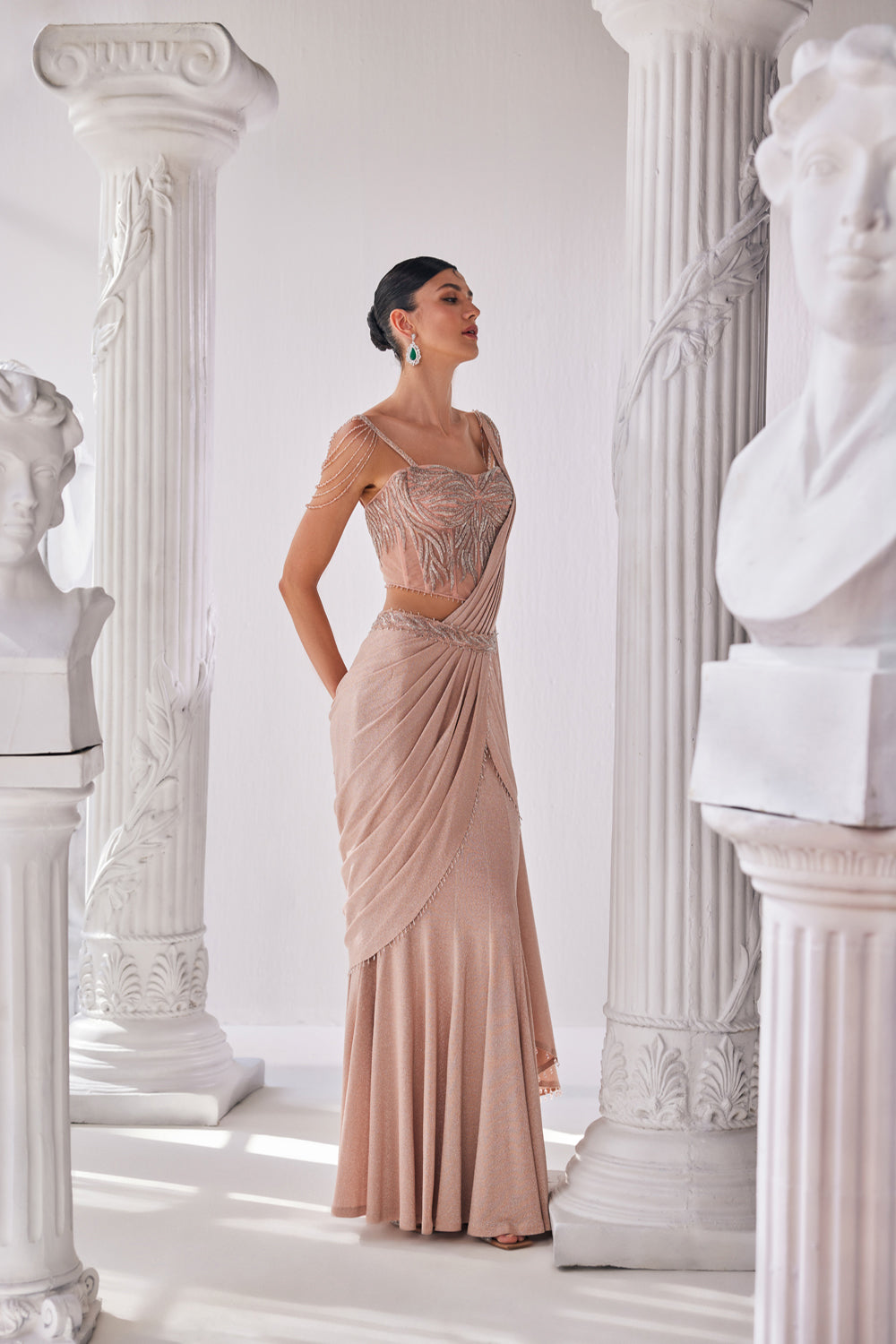 Peach Draped Saree In Luxurious Shimmer Lyrcra. It Is Paired With Anembroidered Corset Blouse And Highlighted With A Statement Belt.
