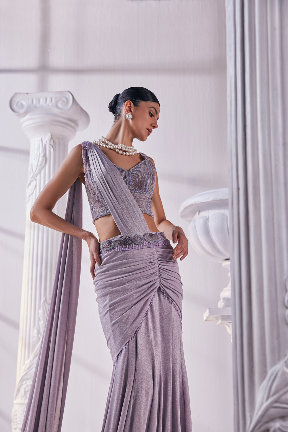 Draped Saree In Luxurious Shimmer Lycra Designed In Lilac Colour, An Emroidered Corset And A Belt.