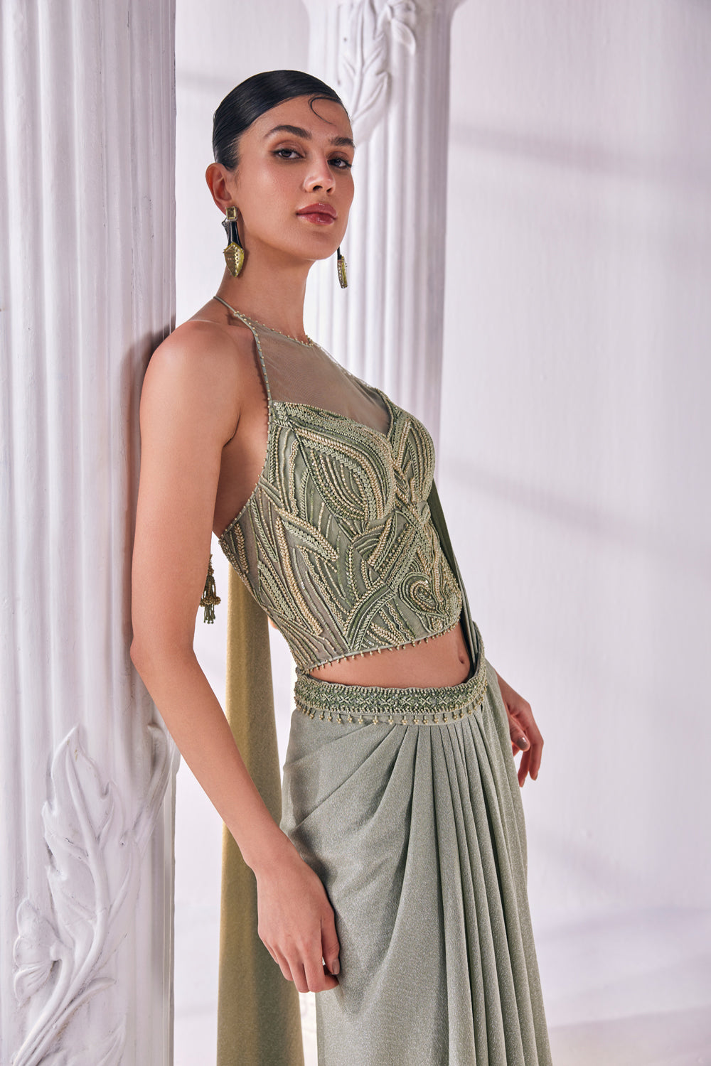 Jade Green Draped Saree In Luxurious Shimmer Lycra Paired With Anemroidered Corset And A Belt.