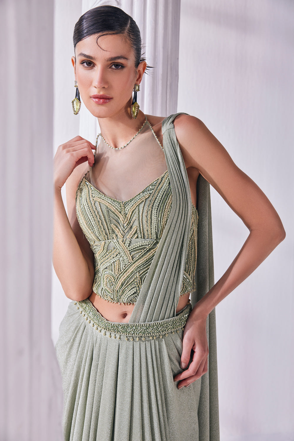 Jade Green Draped Saree In Luxurious Shimmer Lycra Paired With Anemroidered Corset And A Belt.