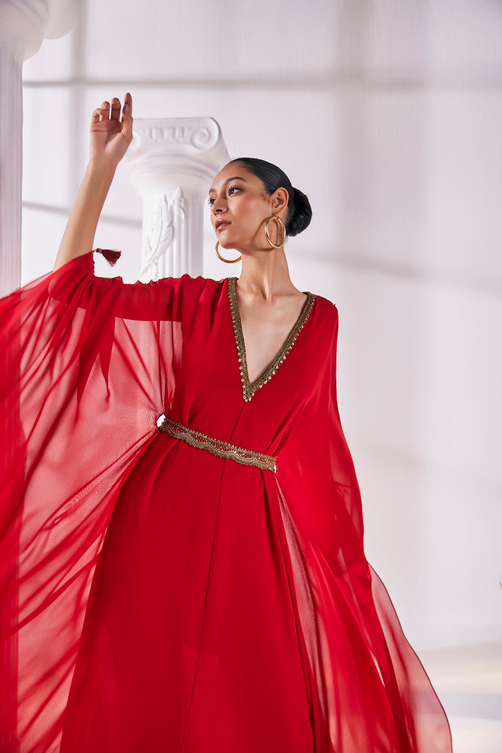Long Kaftan Designed In A Royal Georgette Fabric Features A Plunging Neckline With Beautiful Intricate Hand Embroidery Along With An Embroidered Belt.