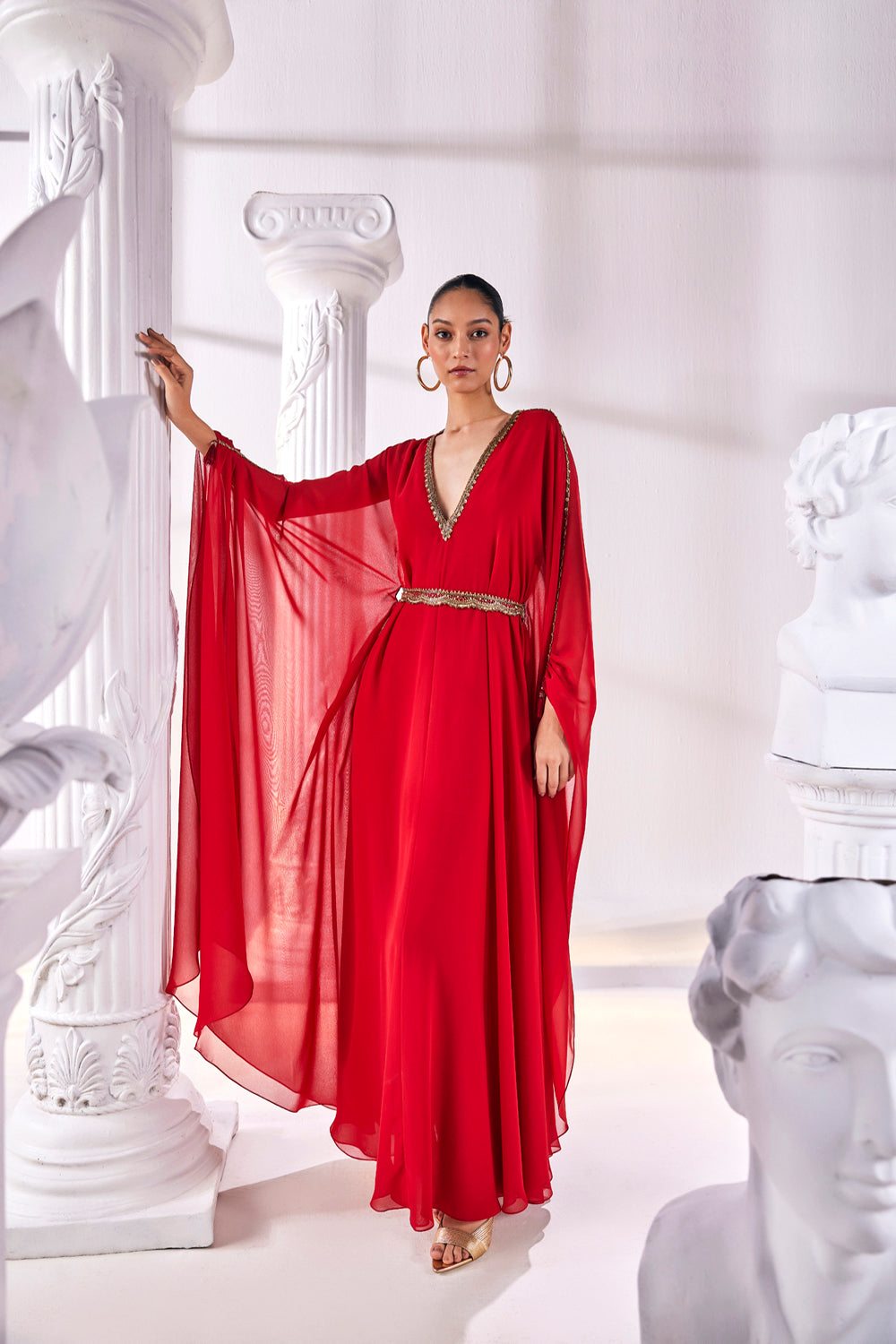 Long Kaftan Designed In A Royal Georgette Fabric Features A Plunging Neckline With Beautiful Intricate Hand Embroidery Along With An Embroidered Belt.