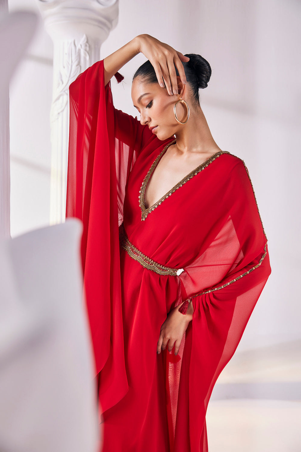 Long Kaftan Designed In A Royal Georgette Fabric Features A Plunging Neckline With Beautiful Intricate Hand Embroidery Along With An Embroidered Belt.