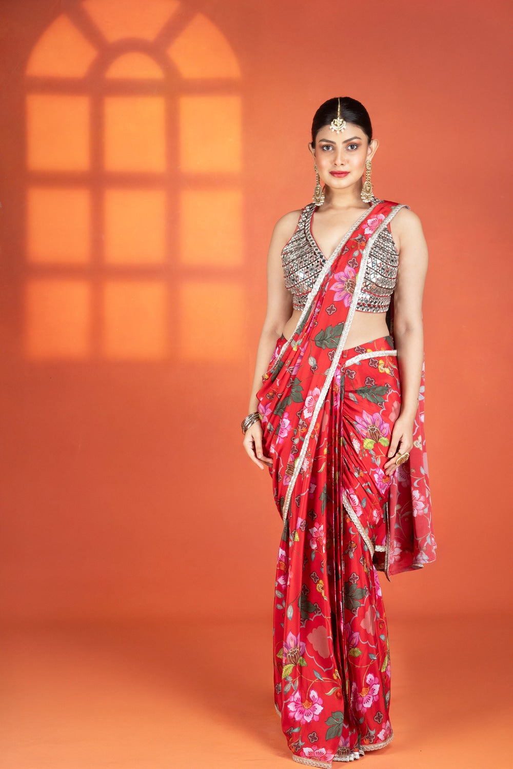 Red floral printed drape saree paired with a heavy mirror-work blouse