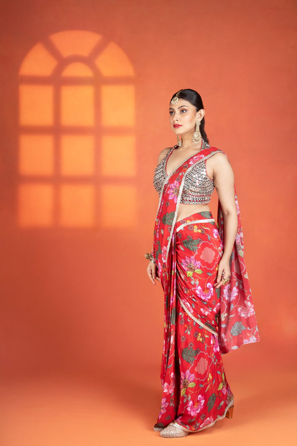 Red floral printed drape saree paired with a heavy mirror-work blouse