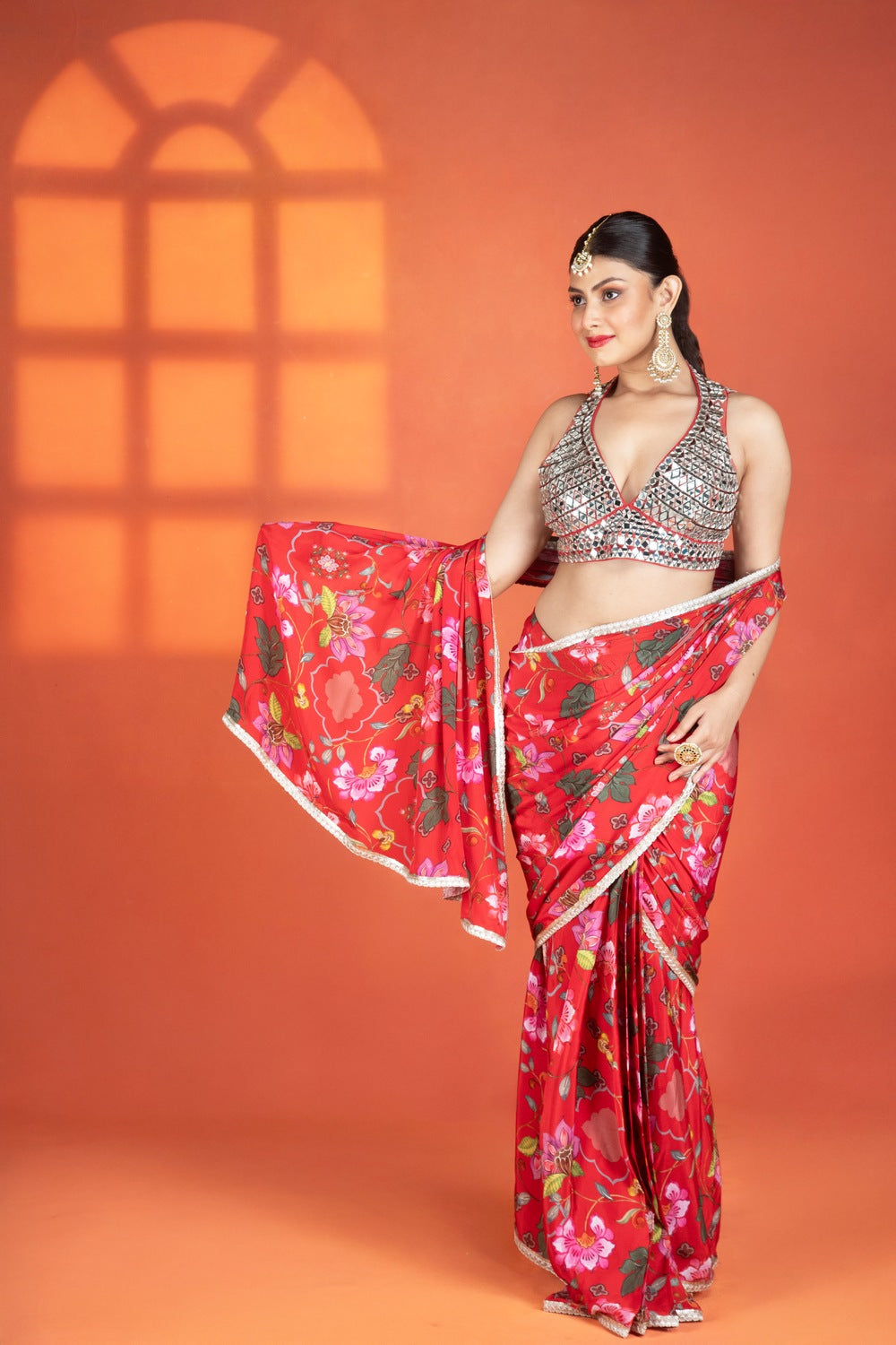 Red floral printed drape saree paired with a heavy mirror-work blouse