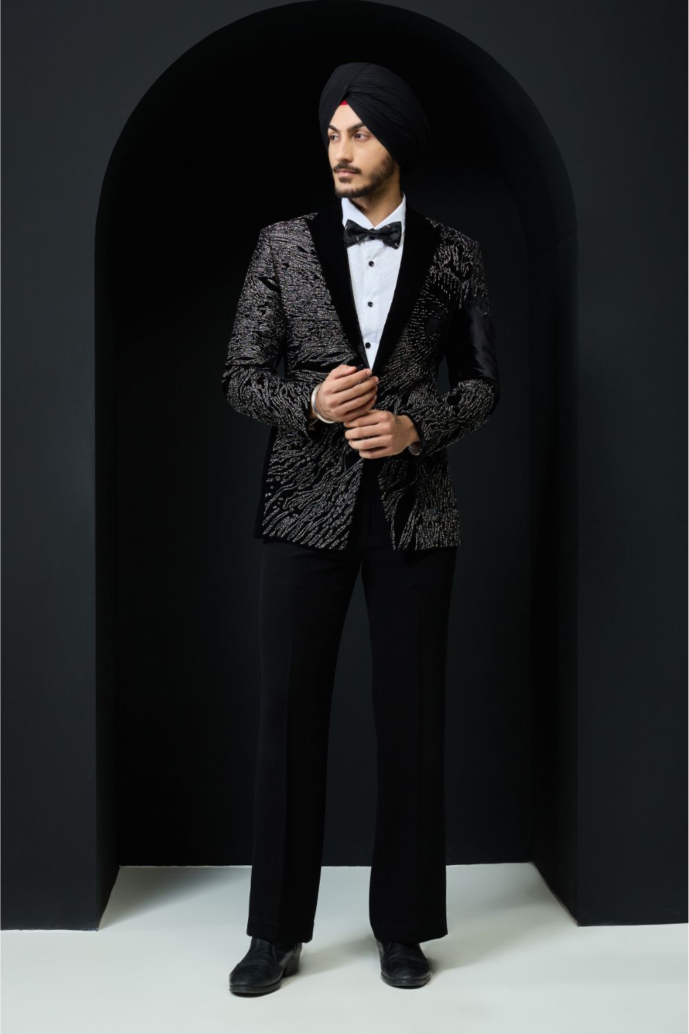 Black tuxedo highlighted with silver zari  and peals