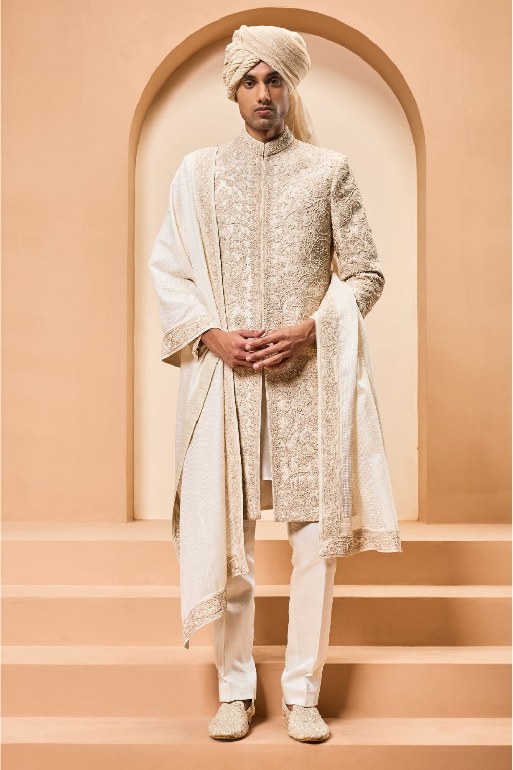 Ivory sherwani detailing with gold zari ,pearl,sequins and spring work