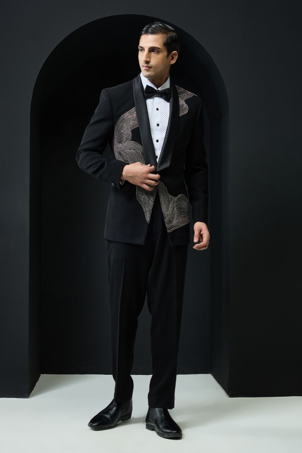 Black tuxedo highlighted with silver zari , cutdana and peals