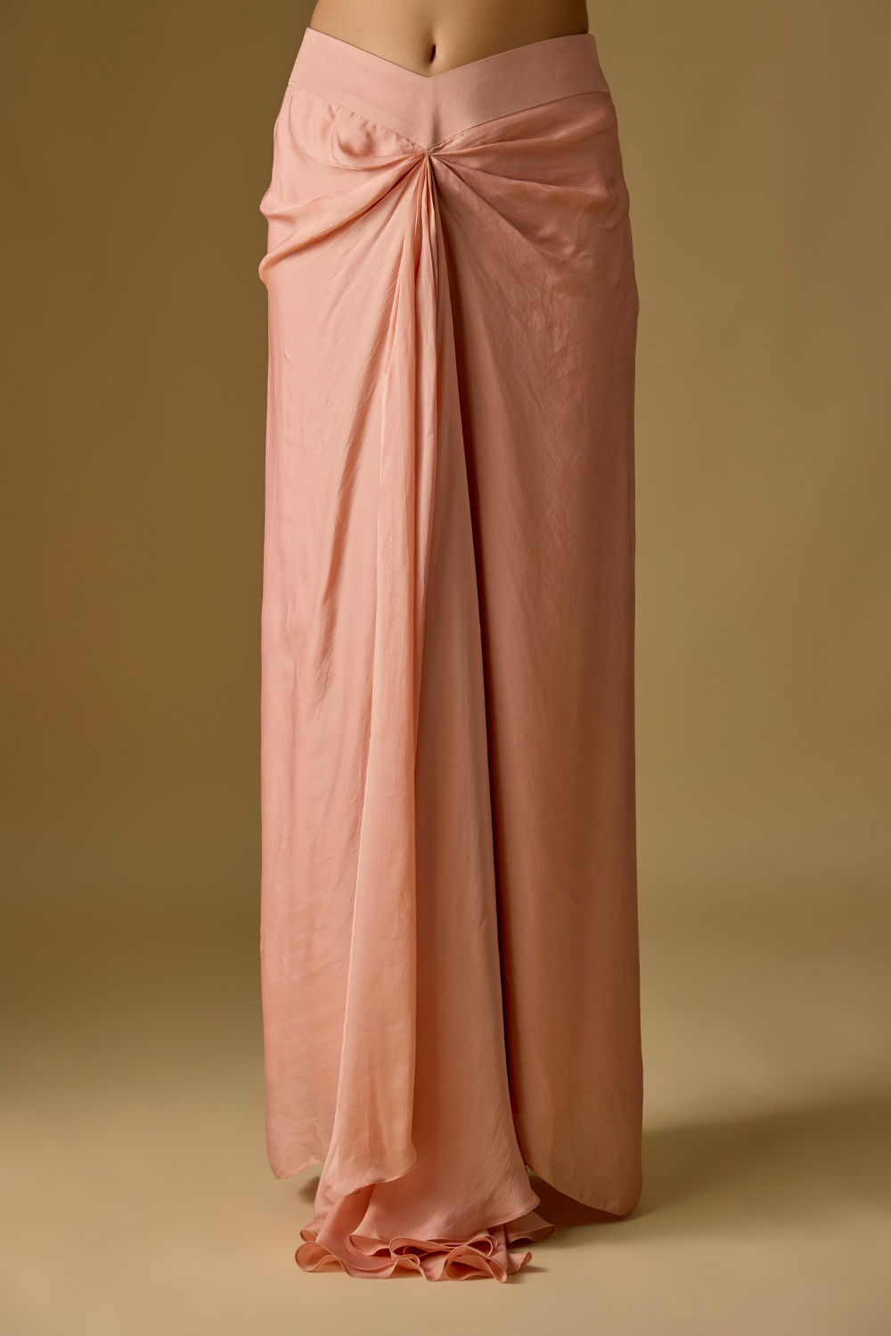 Coraqua- Rose gold short jacket in tulle base with hand embroidery. It is paired with satin organza draped skirt.