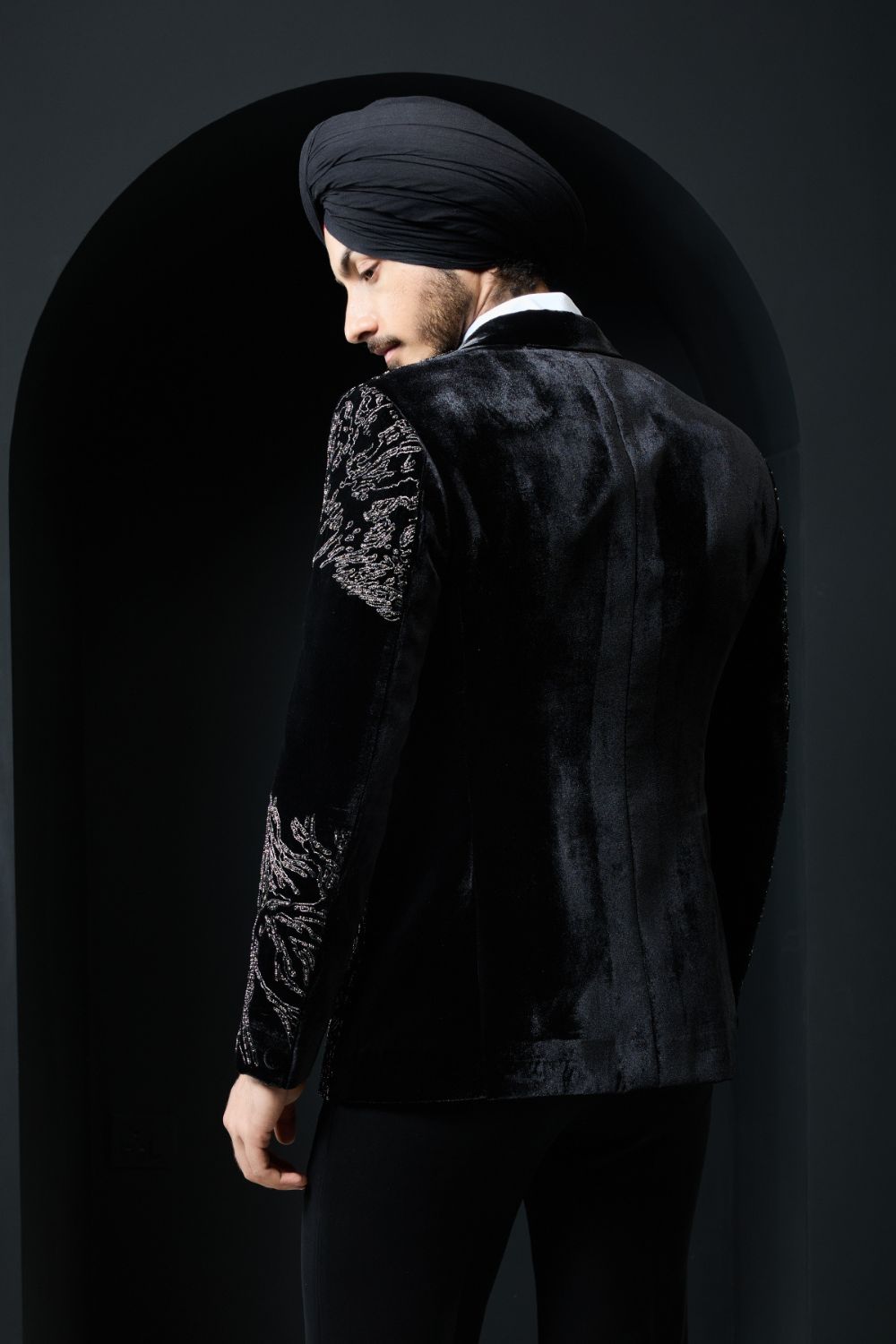 Black tuxedo highlighted with silver zari  and peals