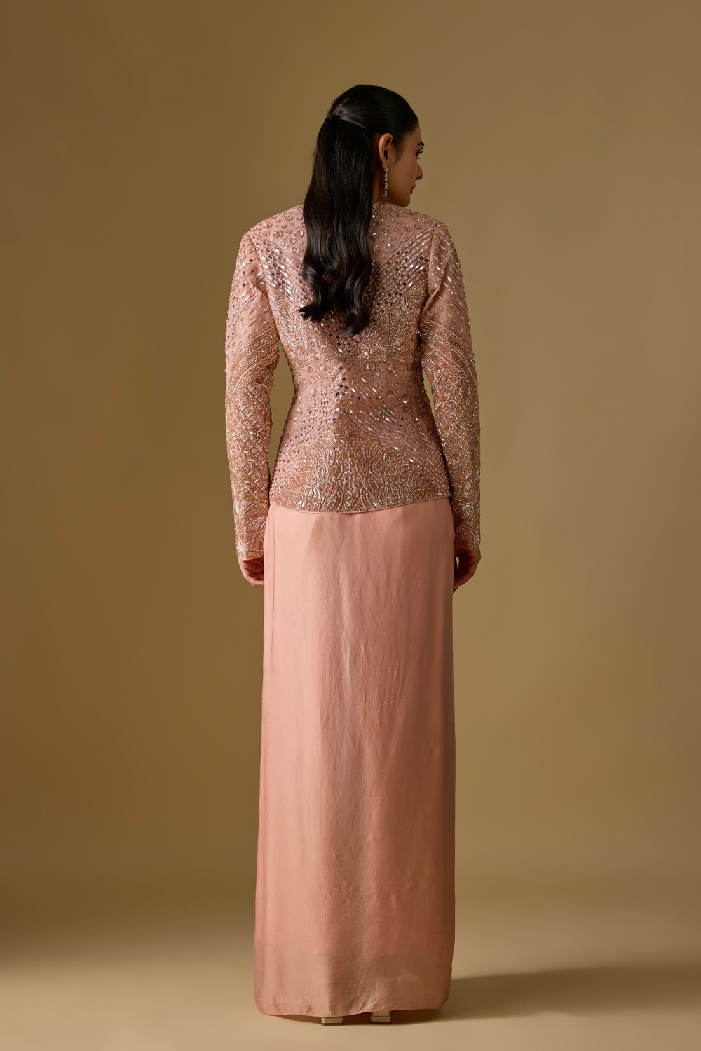 Coraqua- Rose gold short jacket in tulle base with hand embroidery. It is paired with satin organza draped skirt.