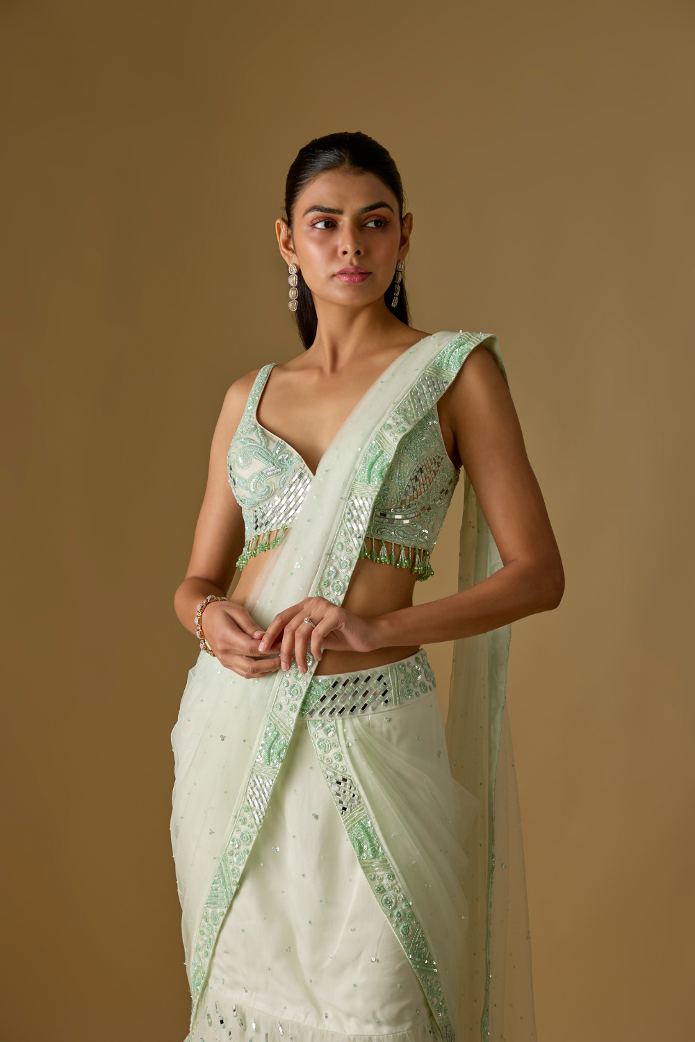Aquaria- Mint designer pre draped saree in satin organza base with hand embroidery. It is paired with a tulle blouse.