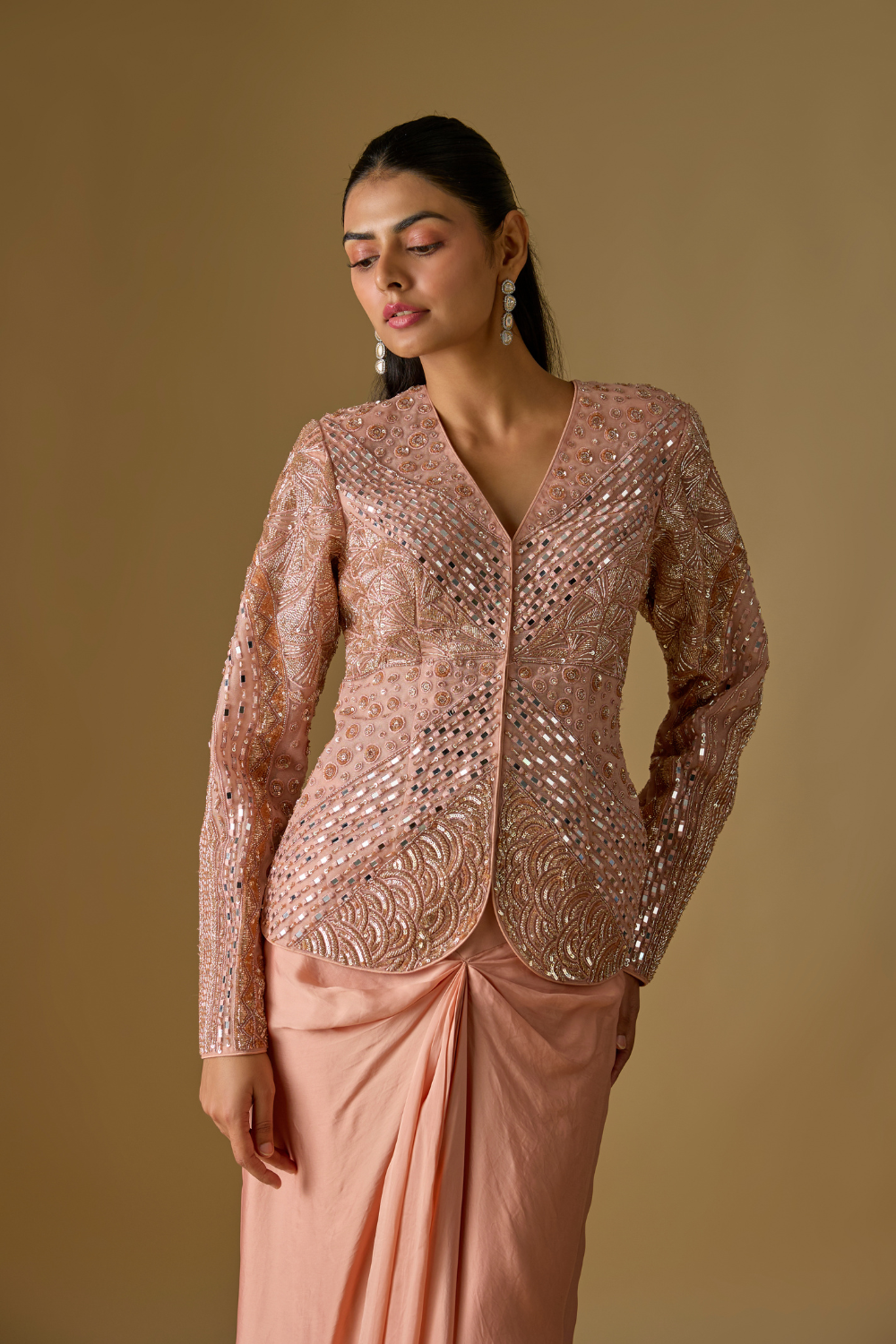 Coraqua- Rose gold short jacket in tulle base with hand embroidery. It is paired with satin organza draped skirt.