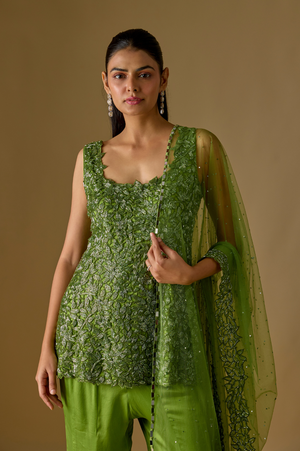 Driftlyn- Olive Green hand-embroidered short kurti paired with sharara and matching dupatta in satin organza and tulle fabric.