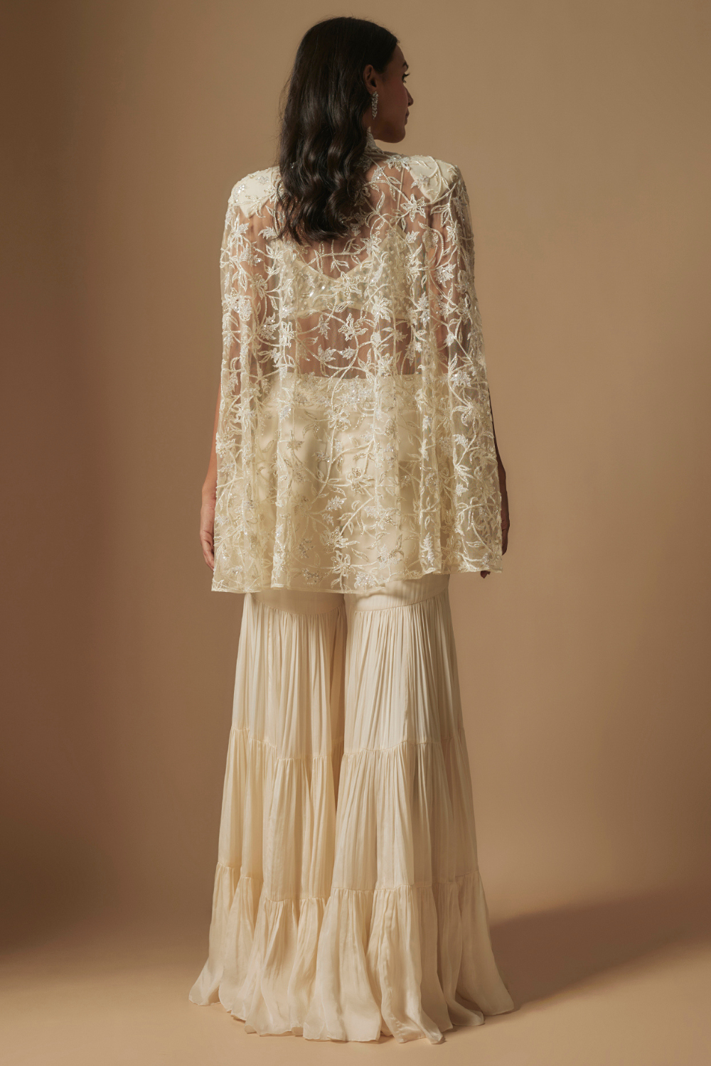 Orlique mirror work blouse paired with embroidered cape and sharara
