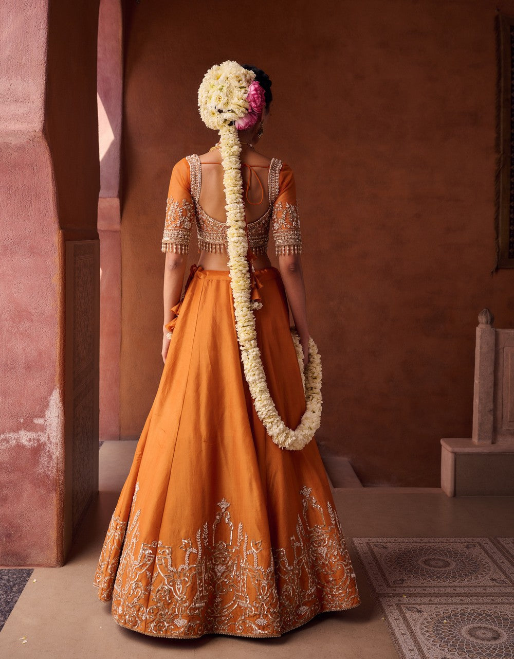 Rust orange embroidered blouse, shimmer tissue lehenga and dupatta