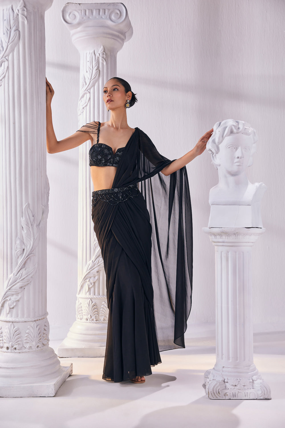 Draped Saree In Royal Georgette Fabric Designed With An Embroidered Bustier And A Statement Belt.