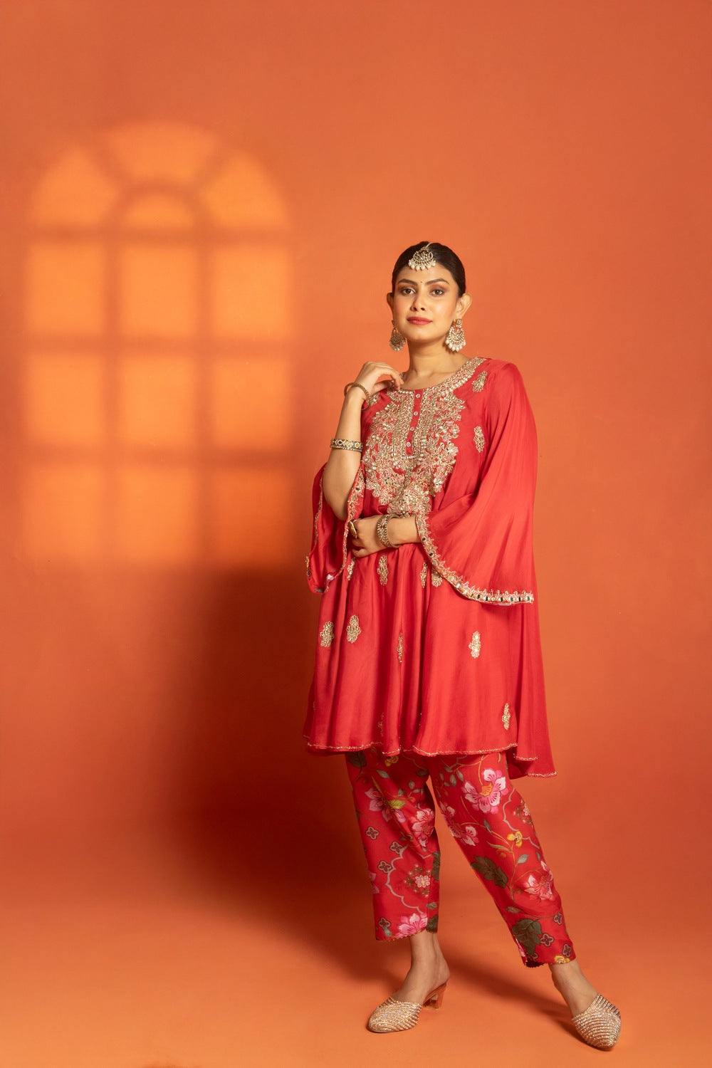 Red Short Semi- Anarkali with a heavily Embroidered Neckline, Paired with Floral Printed Salwar Pants & Dupatta