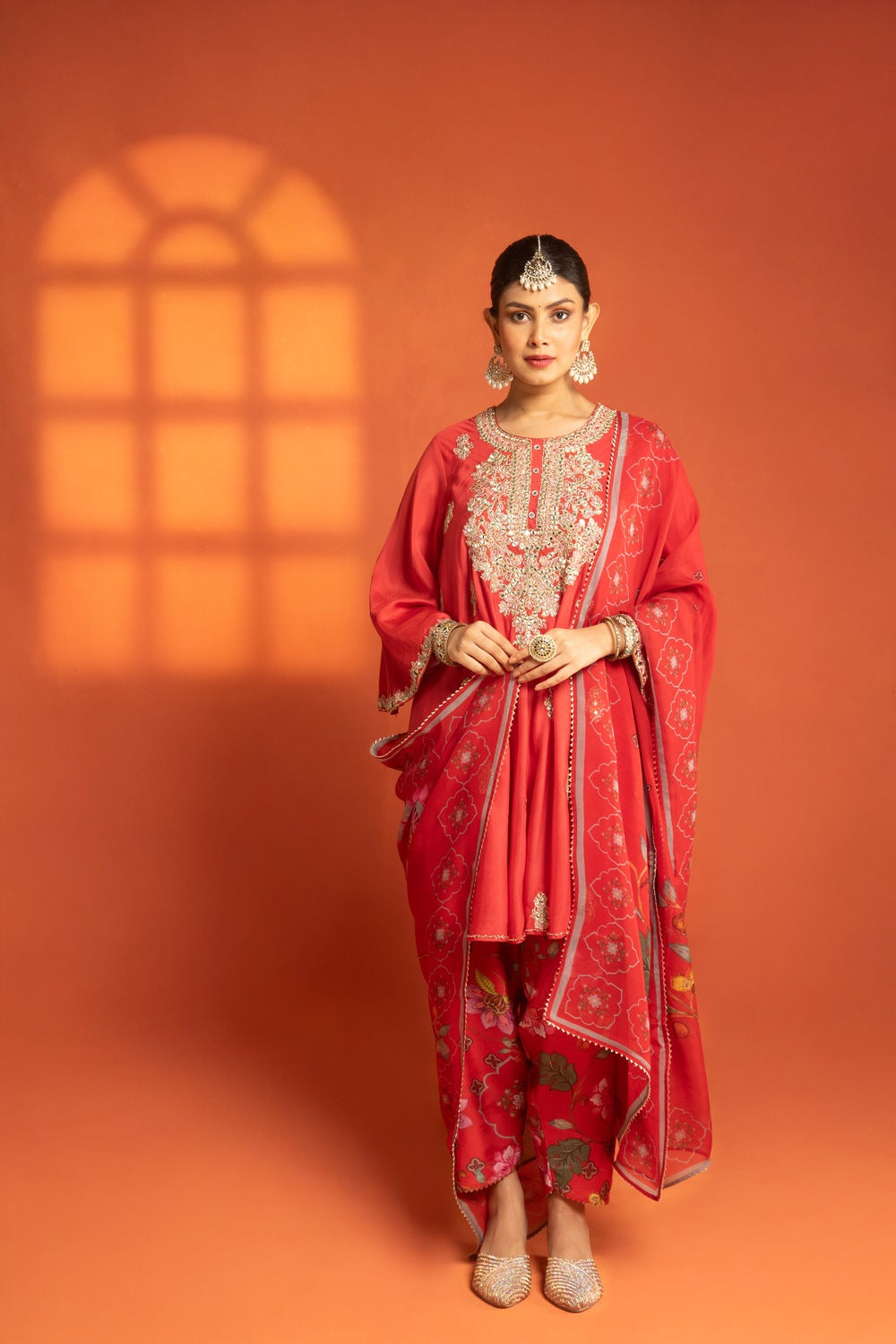 Red Short Semi- Anarkali with a heavily Embroidered Neckline, Paired with Floral Printed Salwar Pants & Dupatta